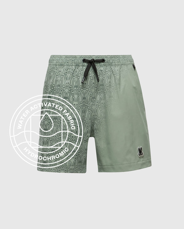 The Psycho Bunny KIDS SAMOS HYDROCHROMIC PRINTED SWIM TRUNK - B0W453F200 features a light green color, black drawstring, subtle bunny pattern, and hydrochromic "Water Activated Fabric" technology highlighted by a water drop icon.