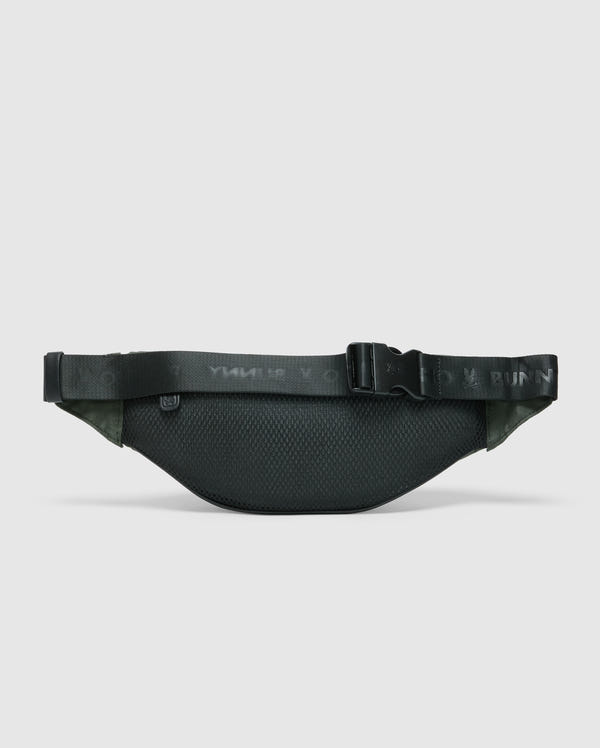 The Psycho Bunny MENS CROSS BODY BAG (B6A181E200) is a black running belt with textured fabric, resembling a casual men's bag. It has an adjustable strap and secure buckle, ideal for carrying small essentials while running or exercising.