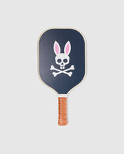 The Psycho Bunny PICKLEBALL PADDLE WITH COVER - B6A277E200 is dark blue with a brown leather grip, featuring a white skull and crossbones with pink and white bunny ears, and a durable honeycomb core for power and control.