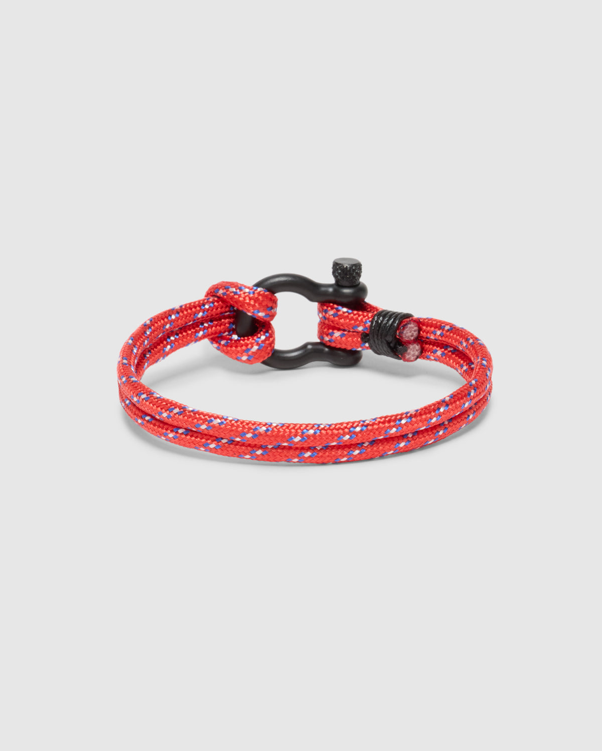 The Psycho Bunny Men's Rope Bracelet (B6A368E200) is a red and white braided nylon accessory with a black metal clasp, set against a light gray background for an elegant and sophisticated look.