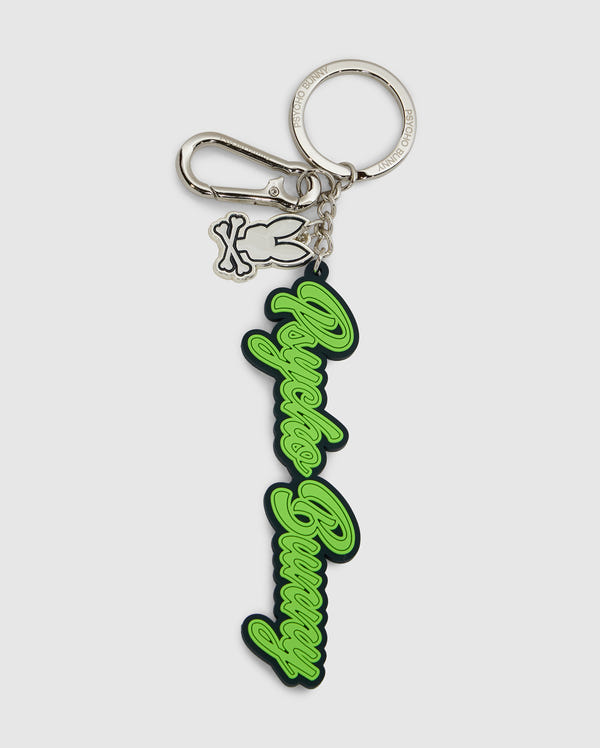 This Psycho Bunny silicone keychain, model B6A373E200, displays the text "Angels Bunny" in elegant green script on a silver keyring with a lobster clasp. It includes an extra charm of a bunny outline, combining practicality with a chic design.