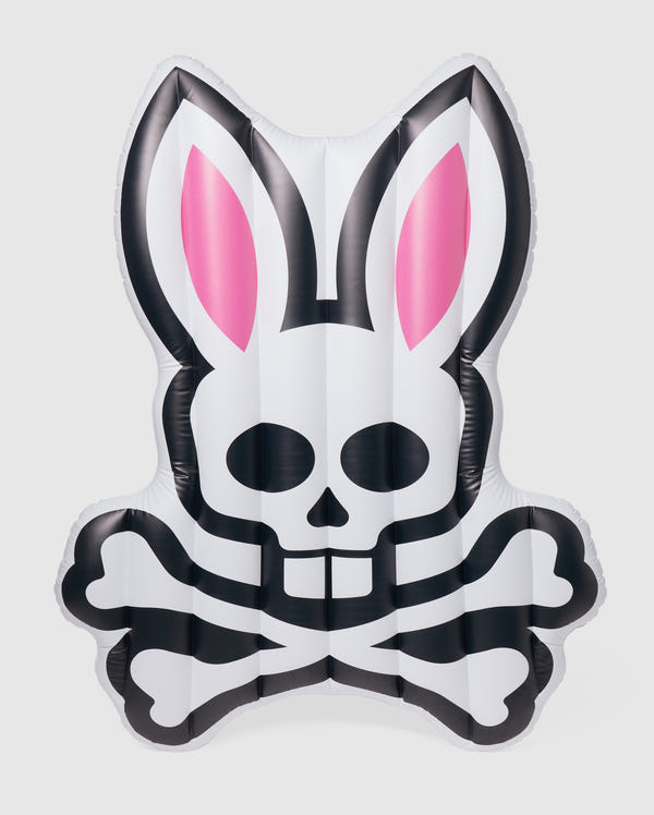 An inflatable pool floatie in the shape of a stylized rabbit's head with pink ears and a skull and crossbones design on the front, this Psycho Bunny POOL FLOATIE - B6A386B200 is primarily white with black accents. Perfect for your next resort vacation, it will make a fun and edgy statement in any pool setting.