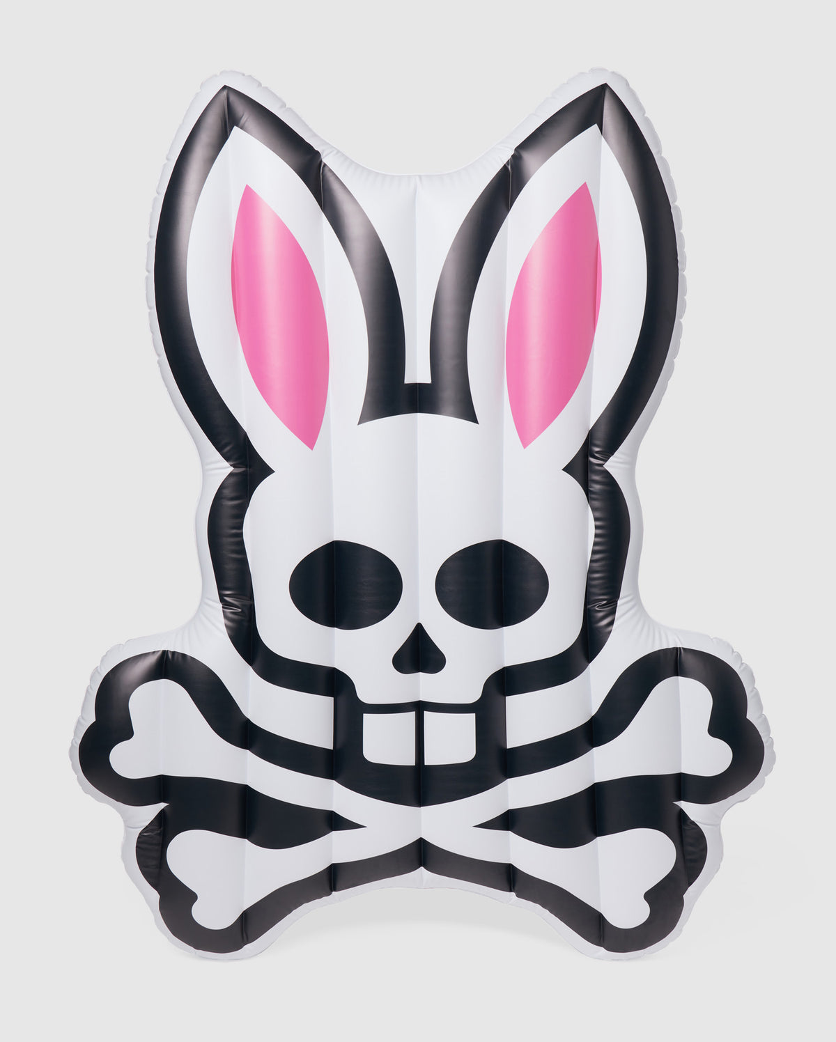 An inflatable pool floatie in the shape of a stylized rabbit's head with pink ears and a skull and crossbones design on the front, this Psycho Bunny POOL FLOATIE - B6A386B200 is primarily white with black accents. Perfect for your next resort vacation, it will make a fun and edgy statement in any pool setting.