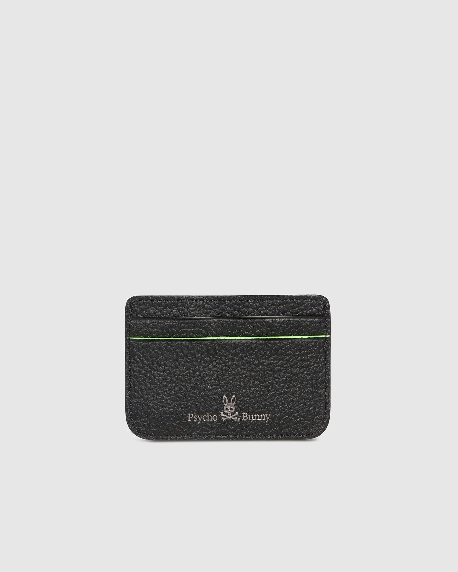 A black, compact grained leather cardholder with green trim. The CARD CASE - B6A409B200 features the Psycho Bunny patch and text on the front, showcasing a minimalist design with card slots visible at the top. The background is plain white.