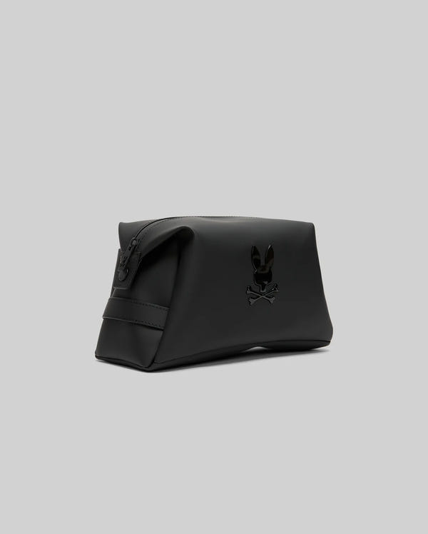 The Psycho Bunny MENS RUBBERIZED TOILETRY KIT - B6A636F200 is a black rectangular bag with a zip closure and embossed bunny skull logo, ideal for organizing travel essentials, shown on a plain gray background.