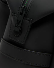 Close-up of the Psycho Bunny MENS RUBBERIZED TOILETRY KIT (B6A636F200) shows a black matte zip with a bunny skull and crossbones pull tab, detailed stitching, and green thread—ideal for keeping your essentials secure.