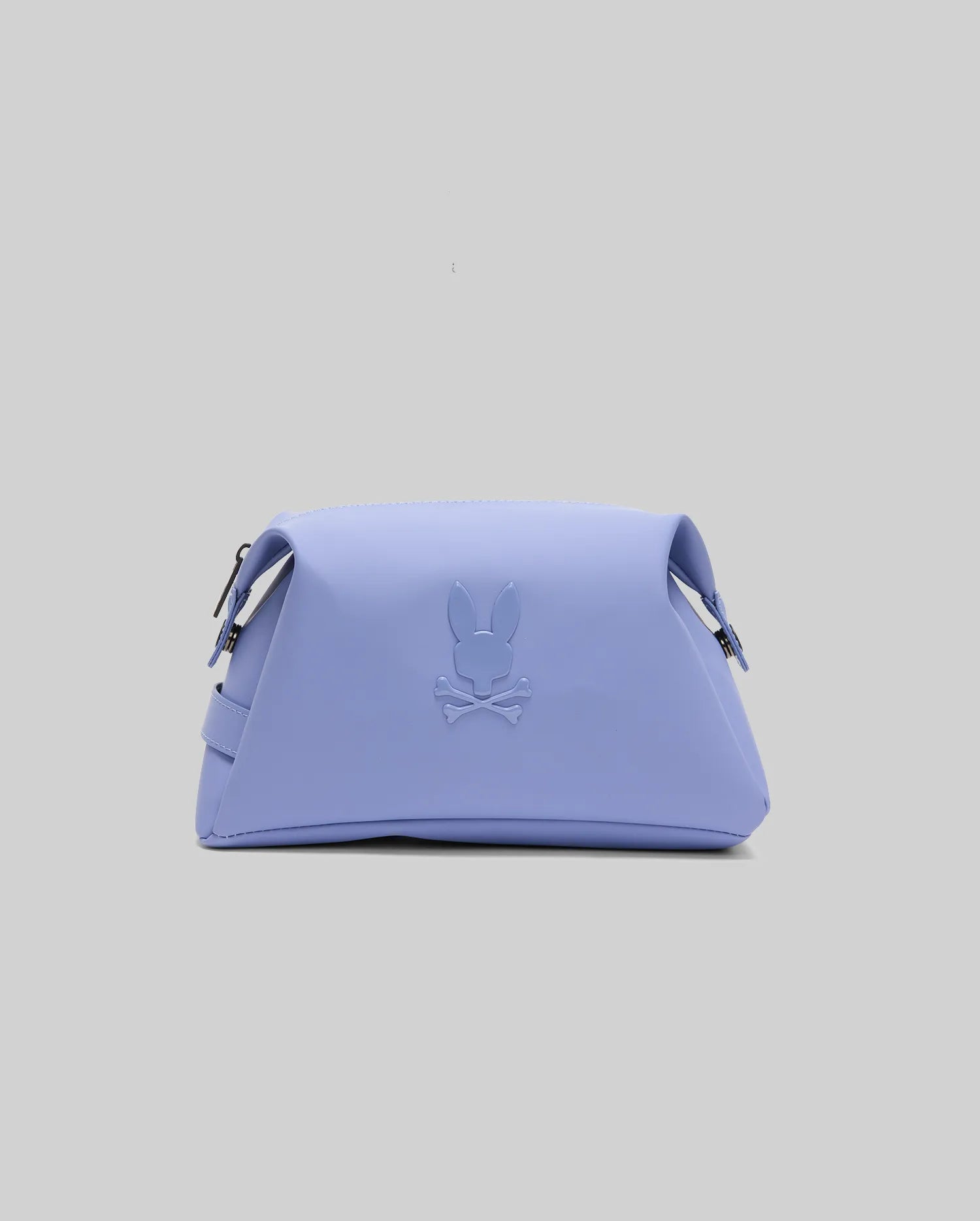 The Psycho Bunny MENS RUBBERIZED TOILETRY KIT - B6A636F200 is a pastel purple travel organizer with a Bunny embossed logo, crossbones, dual silver zippers, and a sleek geometric design—perfect for stylish travelers.