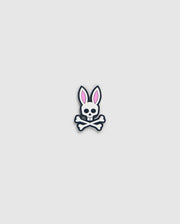 A graphic of a bunny skull and crossbones from the Psycho Bunny golfers collection. The skull has rabbit ears with pink interiors and a small bow tie under the chin. Crossbones form an "X" below the skull, perfect as the Psycho Bunny BALL MARKER - B6A698C200 with its playful design on a plain, light gray background.