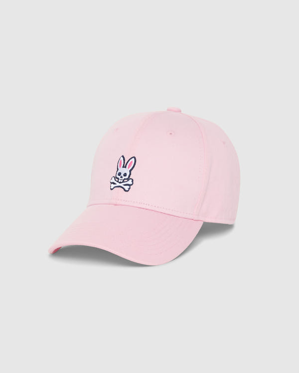 The MENS CLASSIC BASEBALL CAP - B6A816A1HT by Psycho Bunny is a timeless light pink baseball cap, meticulously crafted from 100% cotton, and showcased against a plain background. It features an embroidered design on the front, depicting a white bunny head with crossbones underneath. The bunny sports pink ears and black outlines, imparting a playful touch to this classic accessory.