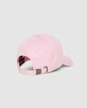 A light pink Psycho Bunny Mens Classic Baseball Cap (B6A816A1HT) is displayed from the back, showcasing an adjustable metal clasp strap. Crafted from 100% cotton, it features a dark-colored lining and a small logo on the clasp. The plain gray background accentuates the cap’s timeless design.