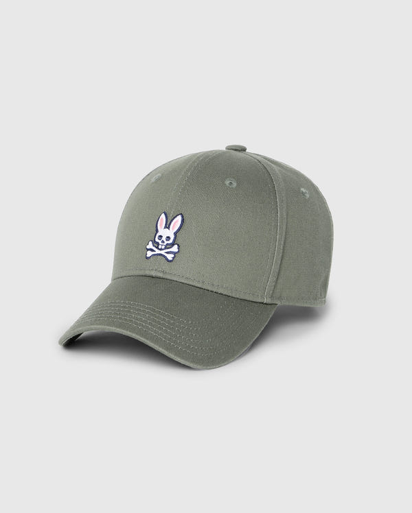 The Psycho Bunny Men's Classic Baseball Cap (B6A816B200) is a stylish green 100% cotton cap featuring a white and pink bunny with crossbones emblem on the front. It has a curved brim, embroidered eyelets, and a solid pattern for a sleek look.