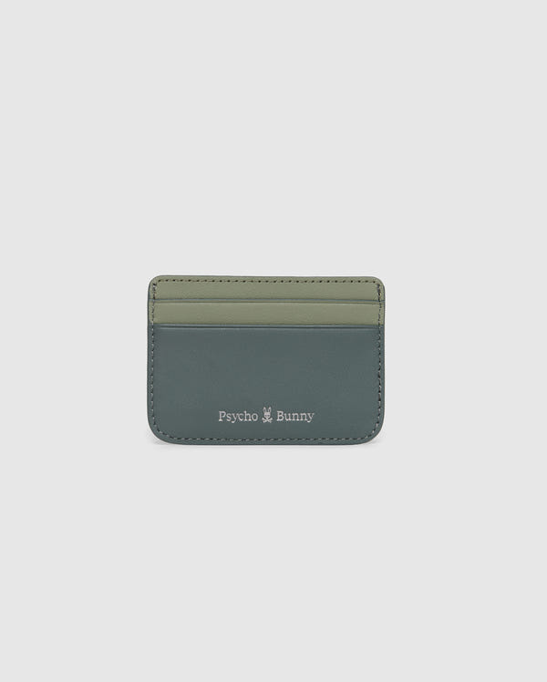 The MENS WORDMARK LEATHER CARD CASE - B6A869D200 by Psycho Bunny is crafted from durable shell pebble leather in two shades of green. It features the brand name and a small white logo at the bottom, ideal for organizing any man's essentials.