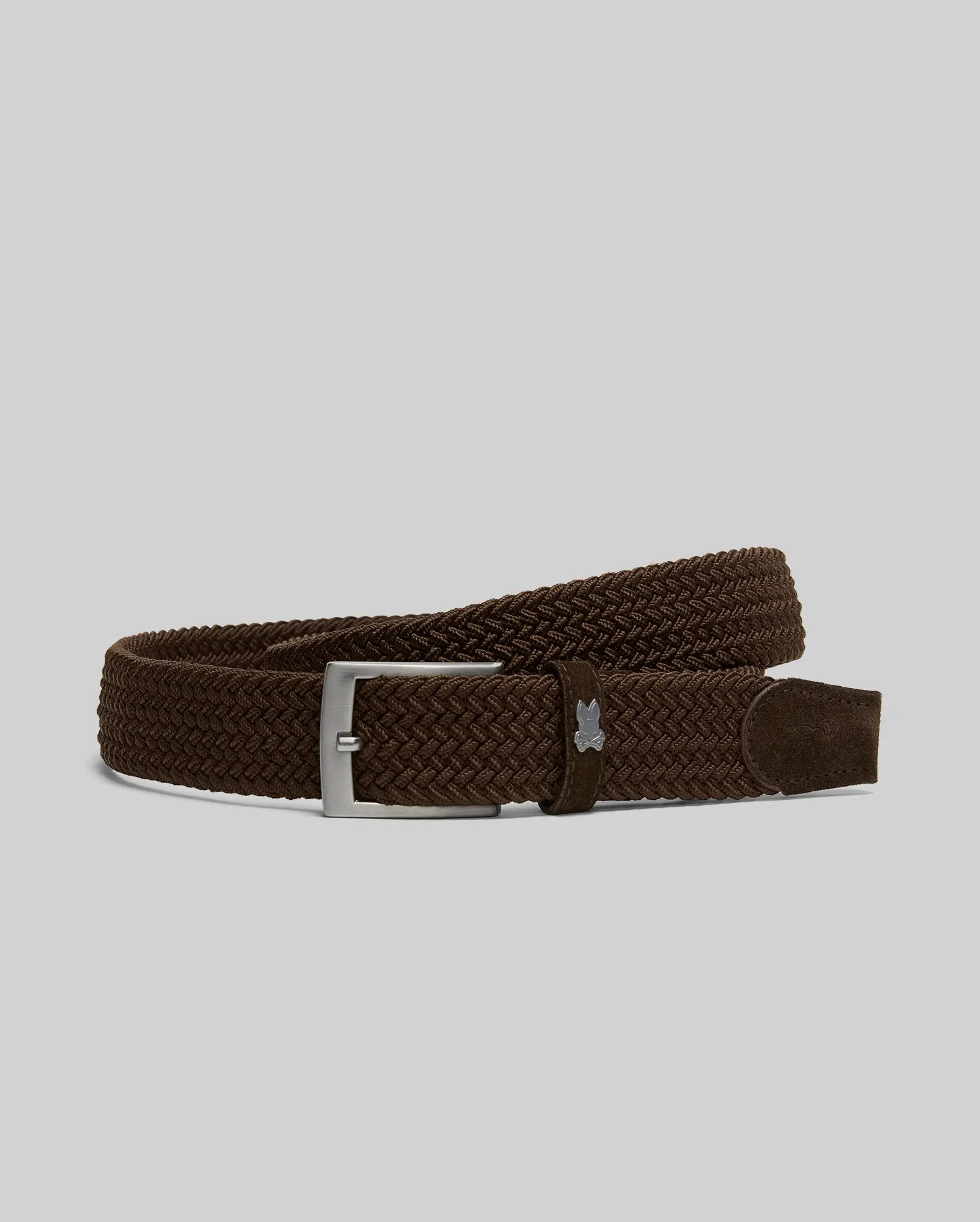 The Psycho Bunny MENS STRETCH BRAIDED BELT - B6A890F200 features a dark brown braided design with a silver rectangular buckle, shown on a light gray background—ideal for any occasion.