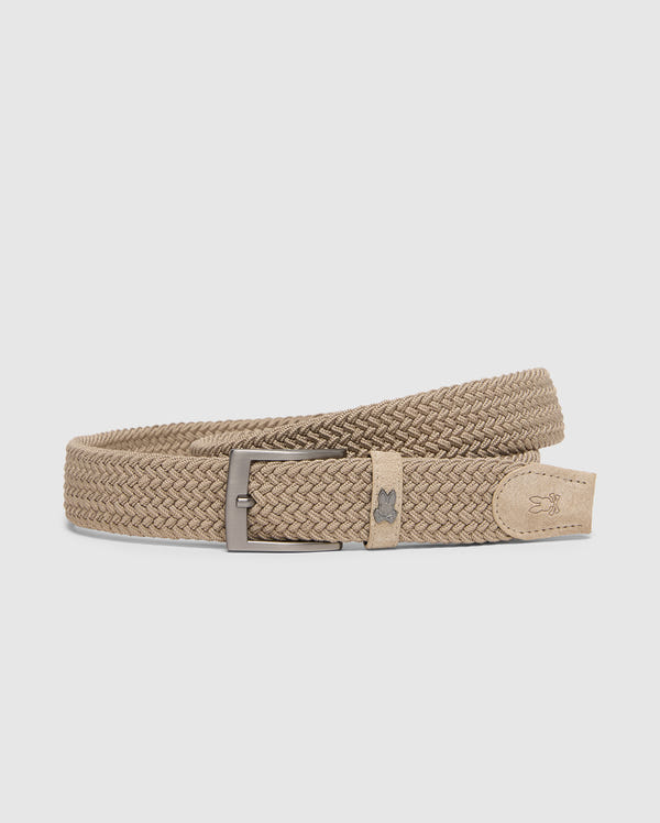 The Psycho Bunny MENS STRETCH BRAIDED BELT - B6A890F200 is a chic beige woven belt with a silver buckle and a subtle logo on the leather loop beside the buckle, elegantly coiled in a spiral against a plain white background.