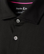 Close-up of a black MENS ARTHUR JERSEY SHIRT - B6C748D200 crafted from Pima cotton, featuring two visible buttons and a small bunny logo. The tag indicates it's from Psycho Bunny and is medium in size. The fabric is soft, smooth, and neatly stitched, epitomizing comfortable shirting.