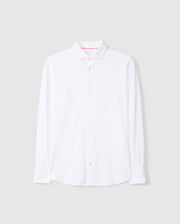 The MENS ARTHUR JERSEY SHIRT - B6C748D200 by Psycho Bunny is presented in a crisp white with a classic collar and long sleeves. Crafted from stretch Pima cotton, it includes a subtle embroidered chest logo. Against a plain gray background, this shirt combines both comfort and elegance.