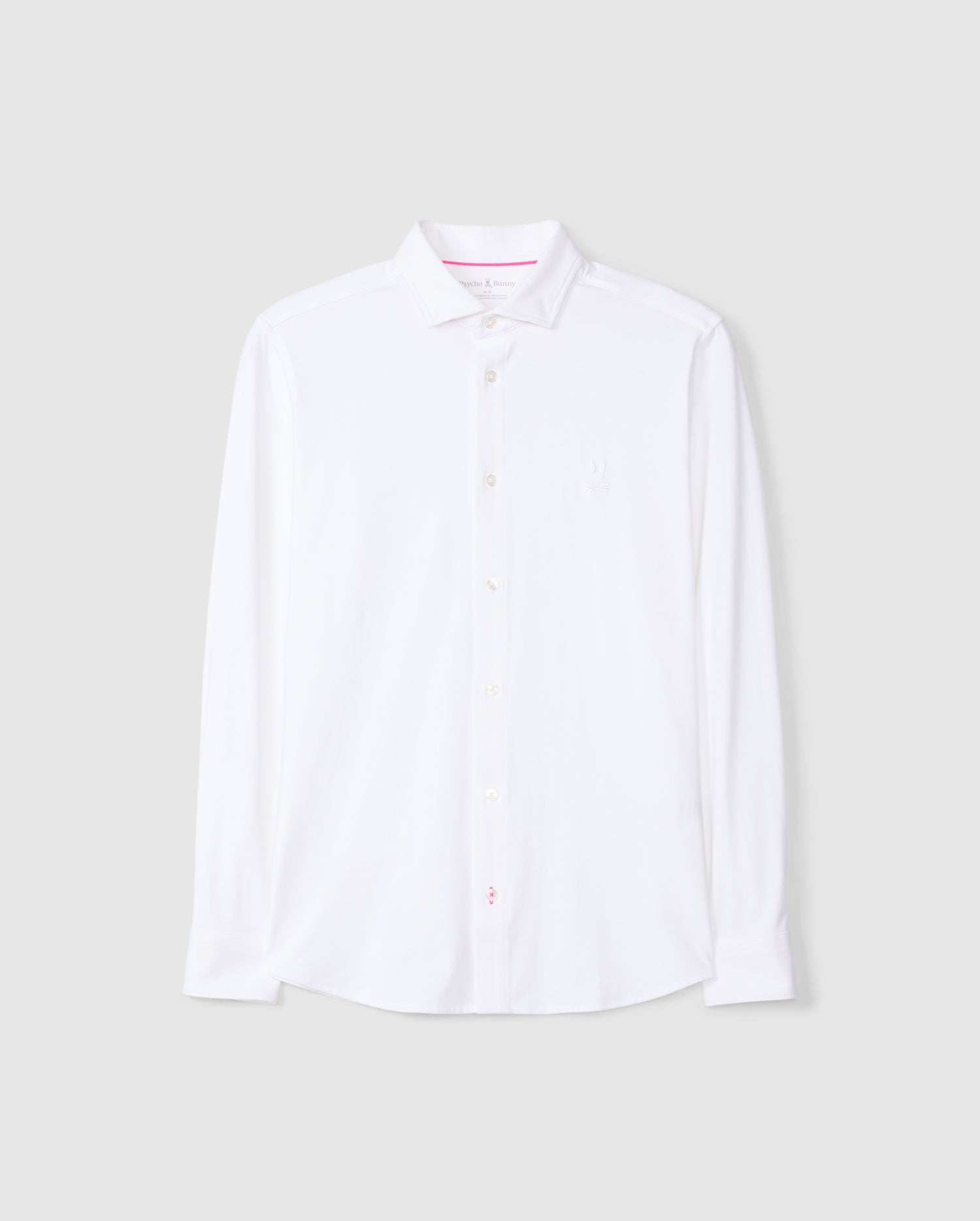 The MENS ARTHUR JERSEY SHIRT - B6C748D200 by Psycho Bunny is presented in a crisp white with a classic collar and long sleeves. Crafted from stretch Pima cotton, it includes a subtle embroidered chest logo. Against a plain gray background, this shirt combines both comfort and elegance.