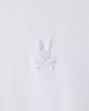 The MENS ARTHUR JERSEY SHIRT - B6C748D200 by Psycho Bunny is made from white jersey fabric and features a discreet embroidered design of a bunny head atop two crossed bones.