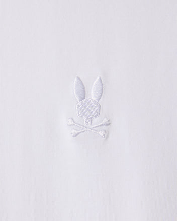 The MENS ARTHUR JERSEY SHIRT - B6C748D200 by Psycho Bunny is made from white jersey fabric and features a discreet embroidered design of a bunny head atop two crossed bones.