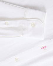 Get a closer look at the timeless MENS ARTHUR JERSEY SHIRT - B6C748D200 from Psycho Bunny, made from smooth stretch Pima cotton. It showcases a sleeve cuff with two white buttons and a distinctive pink button on the shirt front.