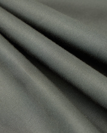 Close-up of the olive green fabric from the Psycho Bunny MENS JARED COTTON MODAL SHIRT - B6C774D200, showcasing its smooth texture and flowing drapes reminiscent of a premium shirt.