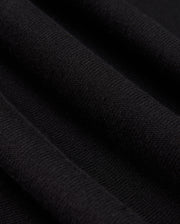 A detailed view of the Psycho Bunny MENS BELMORE EXTRA FINE COTTON SWEATER - B6E832D200 showcases the intricate ribbed texture formed by parallel lines in its extrafine cotton knit. The lighting accentuates the sweater's high-quality stitching, enhancing its soft and luxurious look.