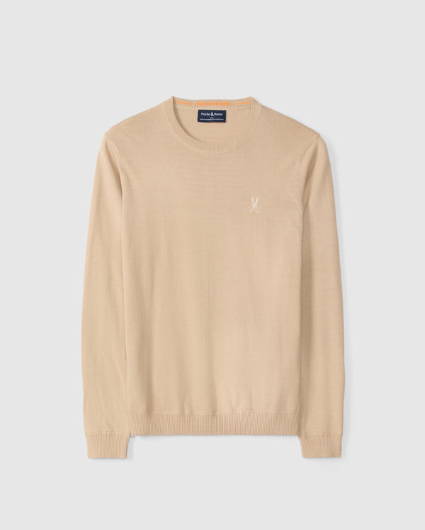 The Psycho Bunny "Mens Belmore Extra Fine Cotton Sweater - B6E832D200" is made from extrafine cotton with a beige long-sleeve crew neck. It features the embroidered Bunny logo on the left chest, ribbed cuffs, and hem, all on a plain white background.