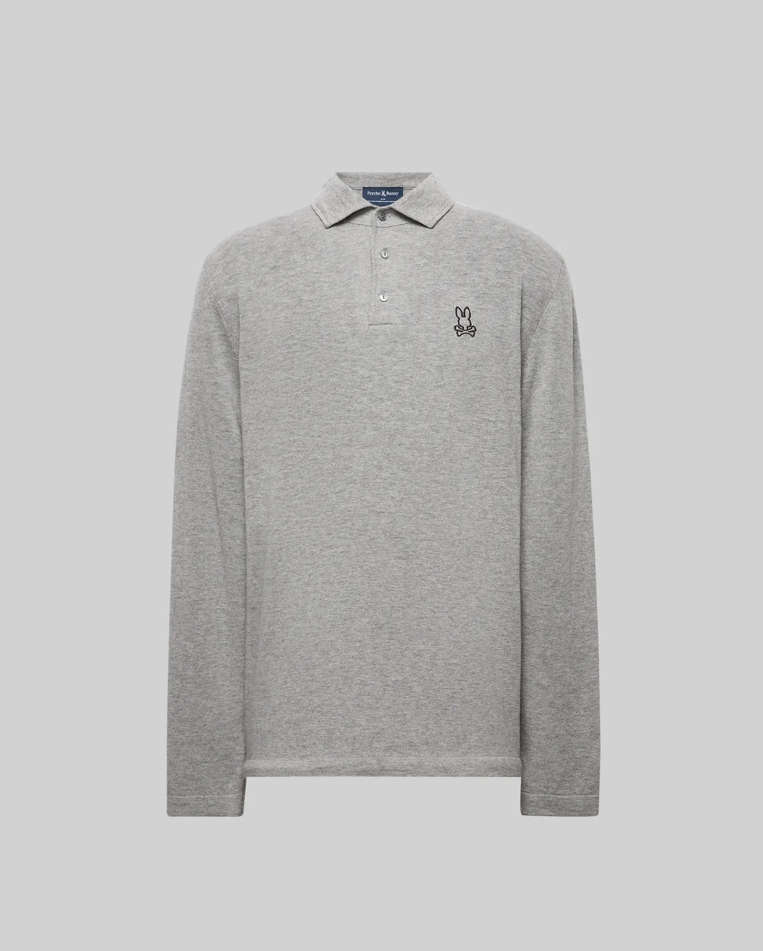 The Psycho Bunny MENS BRADSHAW POLO SWEATER (B6E835D200) is a light grey, long-sleeve merino wool polo with a collar, three mother of pearl buttons, and a small embroidered bunny outline on the left chest. Displayed on a plain light grey background.