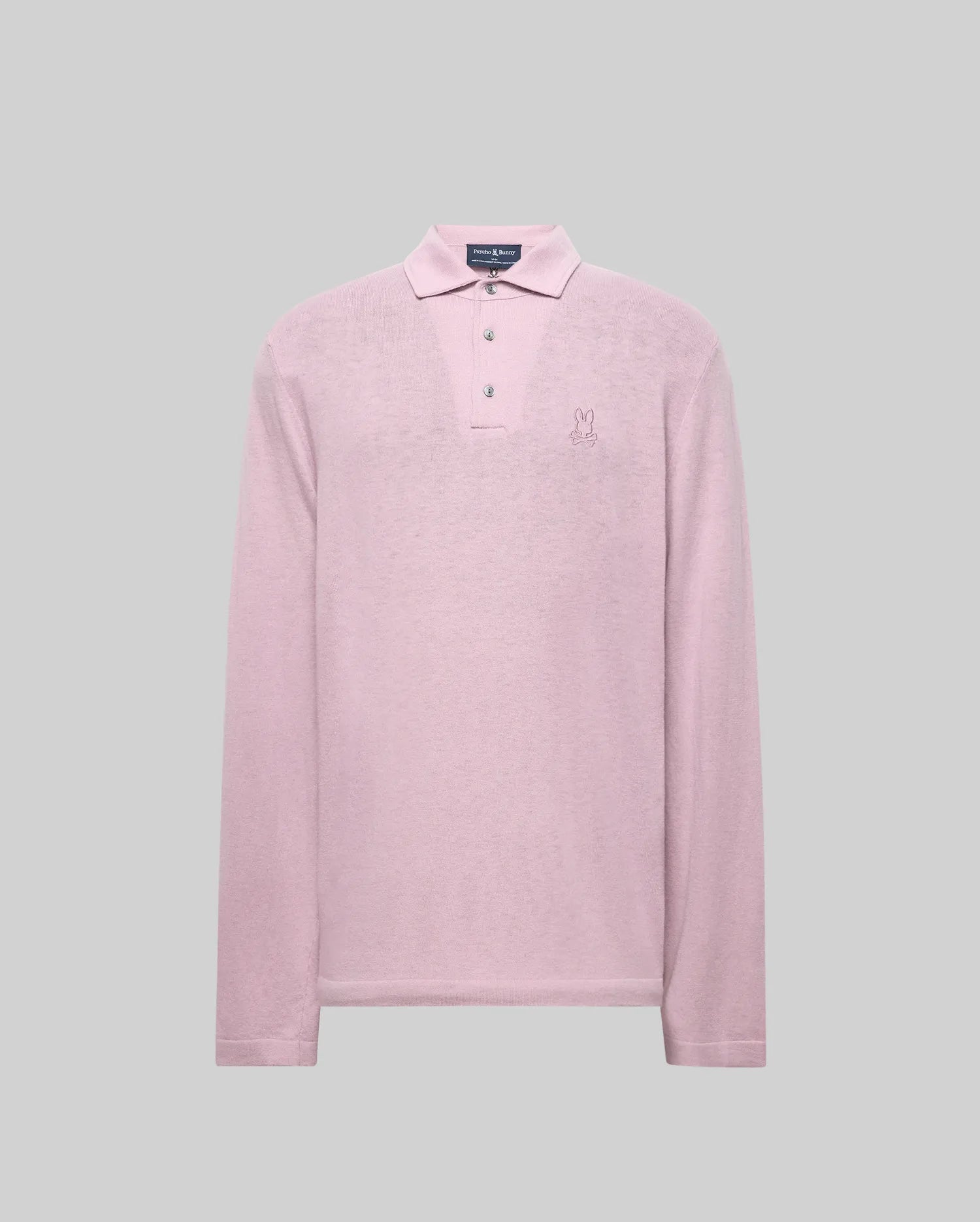 The Psycho Bunny MENS BRADSHAW POLO SWEATER (B6E835D200) is a light pink, long-sleeved merino wool polo with a collar, three mother of pearl buttons, and an embroidered bunny logo on the left chest against a plain gray background.