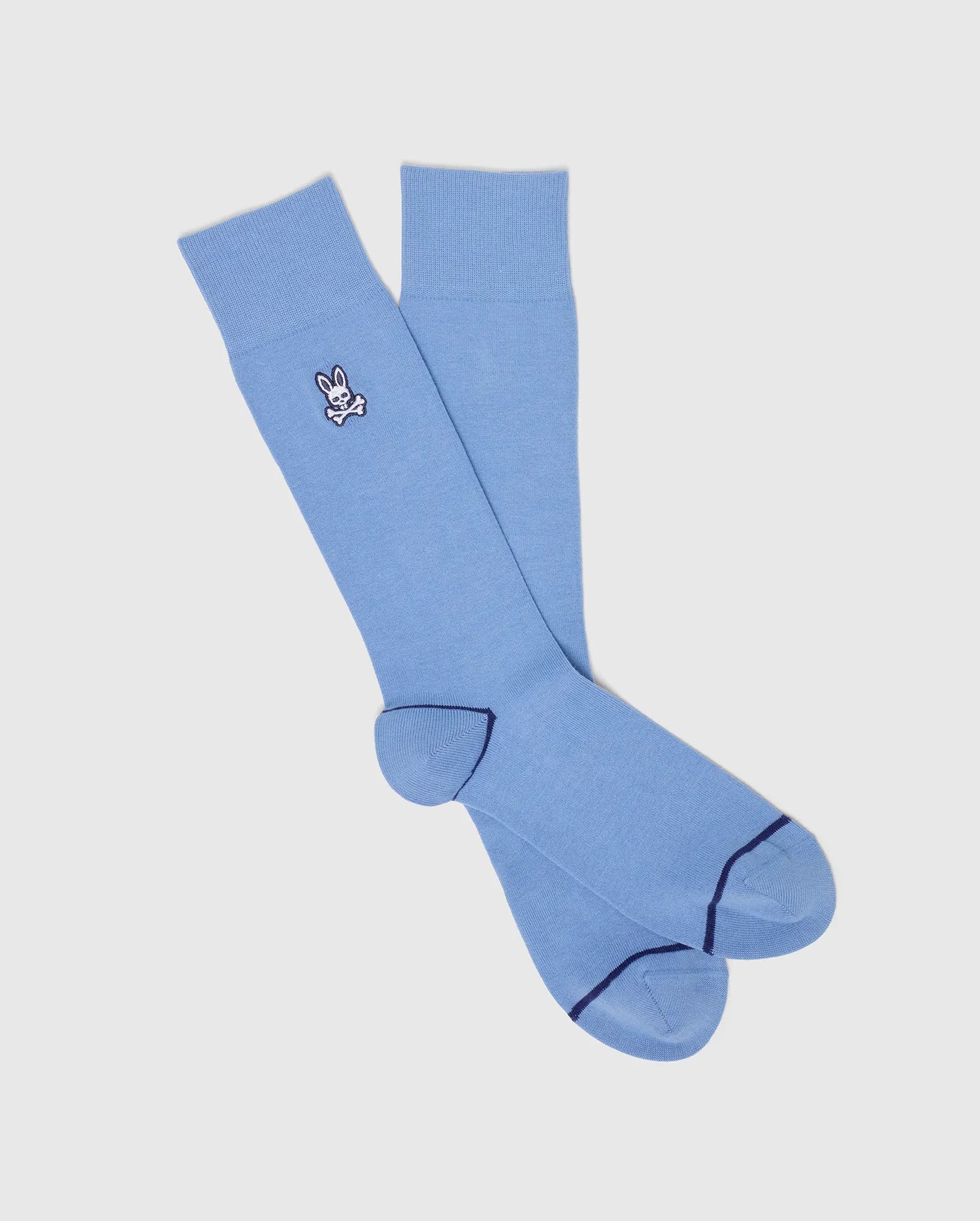The Psycho Bunny MENS 3 PACK DRESS SOCK - B6F504F200 features light blue knee-high socks made from premium Pima cotton. With an embroidered bunny and darker blue accents on the toes and heels, these socks add charm and style to any outfit.