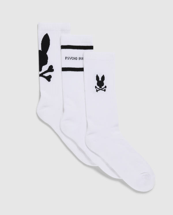The MENS 3 PACK SPORT SOCK - B6F997D200 by Psycho Bunny showcases three pairs of luxurious Peruvian Pima cotton sport socks. One pair is adorned with a prominent black bunny logo and crossbones, the second features a smaller logo above the heel accompanied by "Psycho Bunny" text, and the third sports a small bunny logo with crossbones near the ankle. This versatile 3-pack is perfect for any occasion.