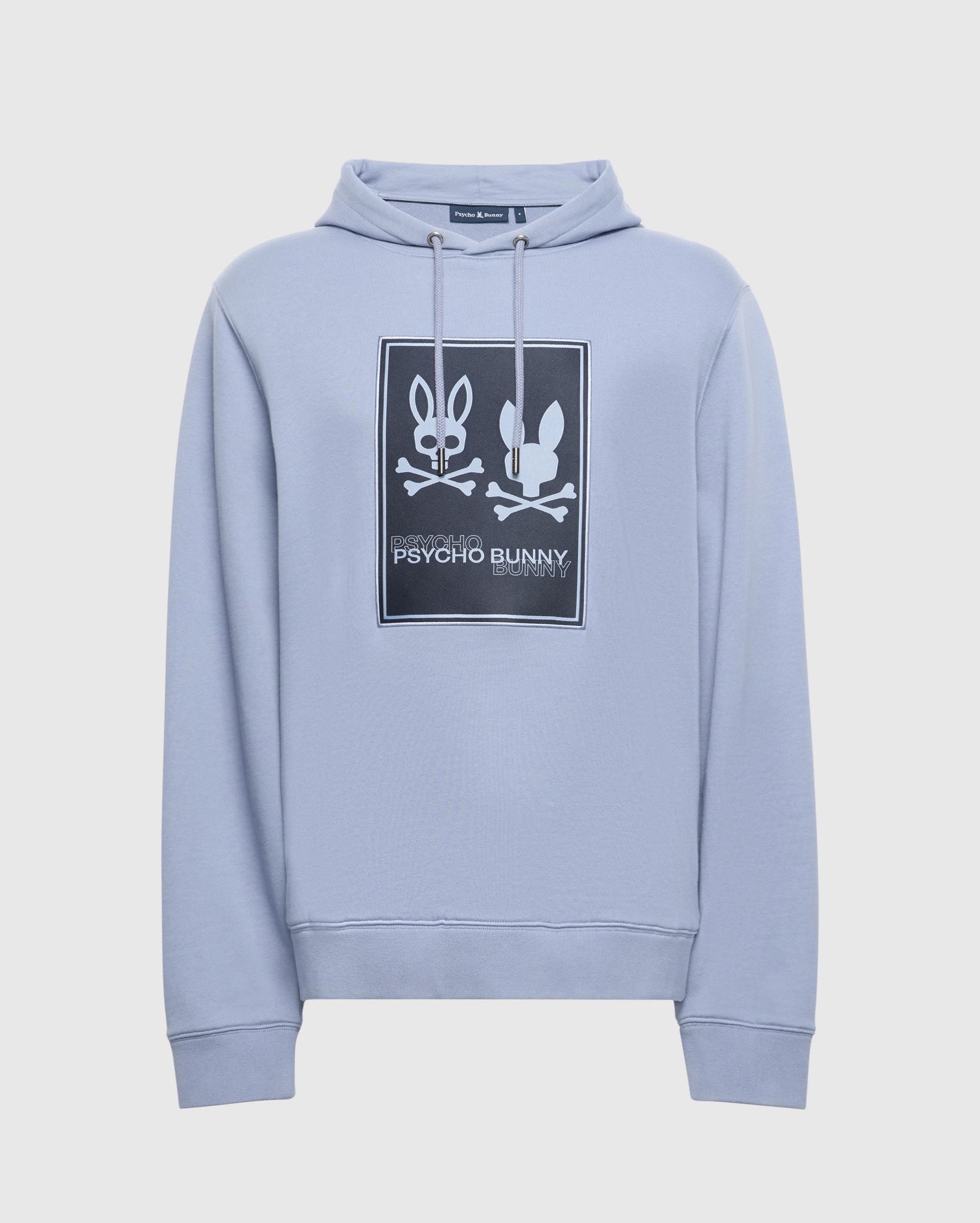 The Psycho Bunny Mens Monroe Twill Patch Fleece Hoodie in light blue features an eye-catching logo appliqué with two stylized rabbits and crossbones, one adorned with a bowtie. Made from French terry fabric, it includes "Psycho Bunny" text along with a hood and long sleeves for enhanced comfort.