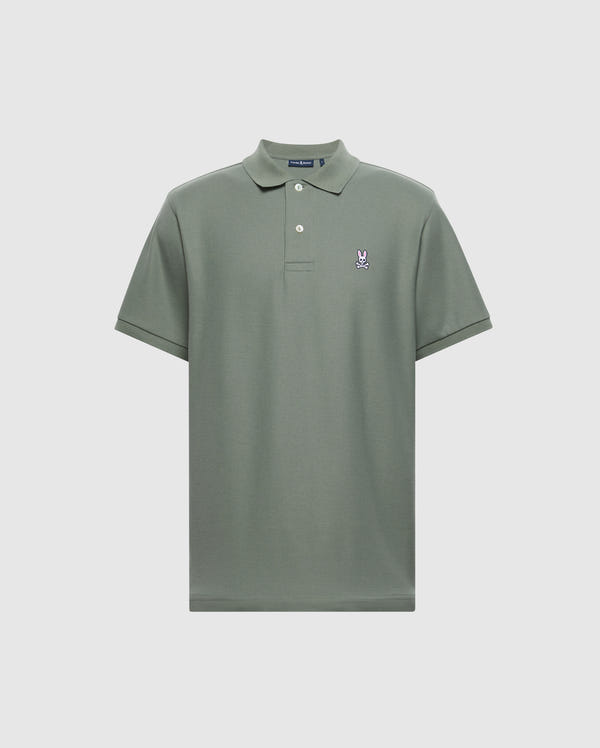 Introducing the MENS CLASSIC PIQUE POLO SHIRT - B6K001B200 by Psycho Bunny. This short-sleeved, sage green polo features a buttoned collar and is crafted from soft Pima cotton. It is adorned with a small embroidered Bunny logo on the left chest, set against a plain light grey backdrop.