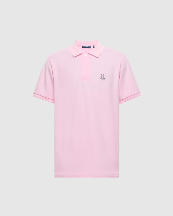 The Psycho Bunny Men's Classic Pique Polo Shirt - B6K001CRPC, is a pink polo made from soft Pima cotton. It features a small embroidered rabbit logo on the left chest, a classic collar, and a button placket against a plain light gray background.