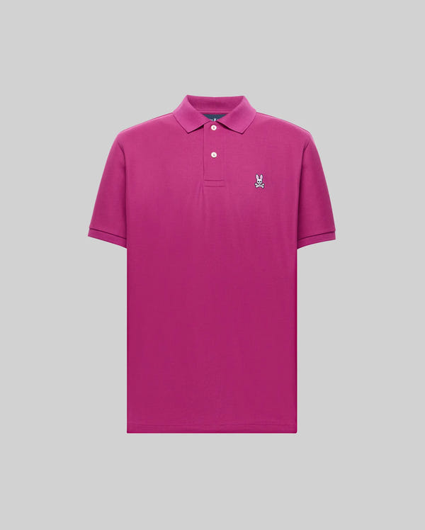 The Psycho Bunny MENS CLASSIC PIQUE POLO SHIRT (B6K001F200) is a bright pink Pima cotton polo featuring a collar, two white buttons, and an embroidered Bunny logo on the left chest, shown against a light gray background.