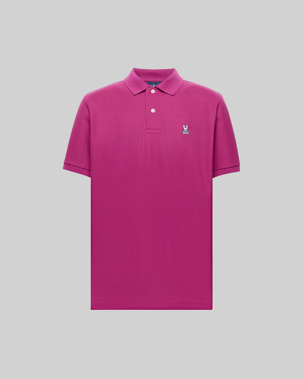 The Psycho Bunny MENS CLASSIC PIQUE POLO SHIRT (B6K001F200) is a bright pink Pima cotton polo featuring a collar, two white buttons, and an embroidered Bunny logo on the left chest, shown against a light gray background.