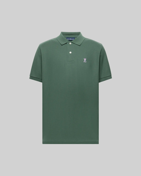 The Psycho Bunny MENS CLASSIC PIQUE POLO SHIRT - B6K001F200 is a dark green men's polo with short sleeves, a collar, two white buttons, and an embroidered white and blue Bunny logo on the left chest, set against a light gray background.