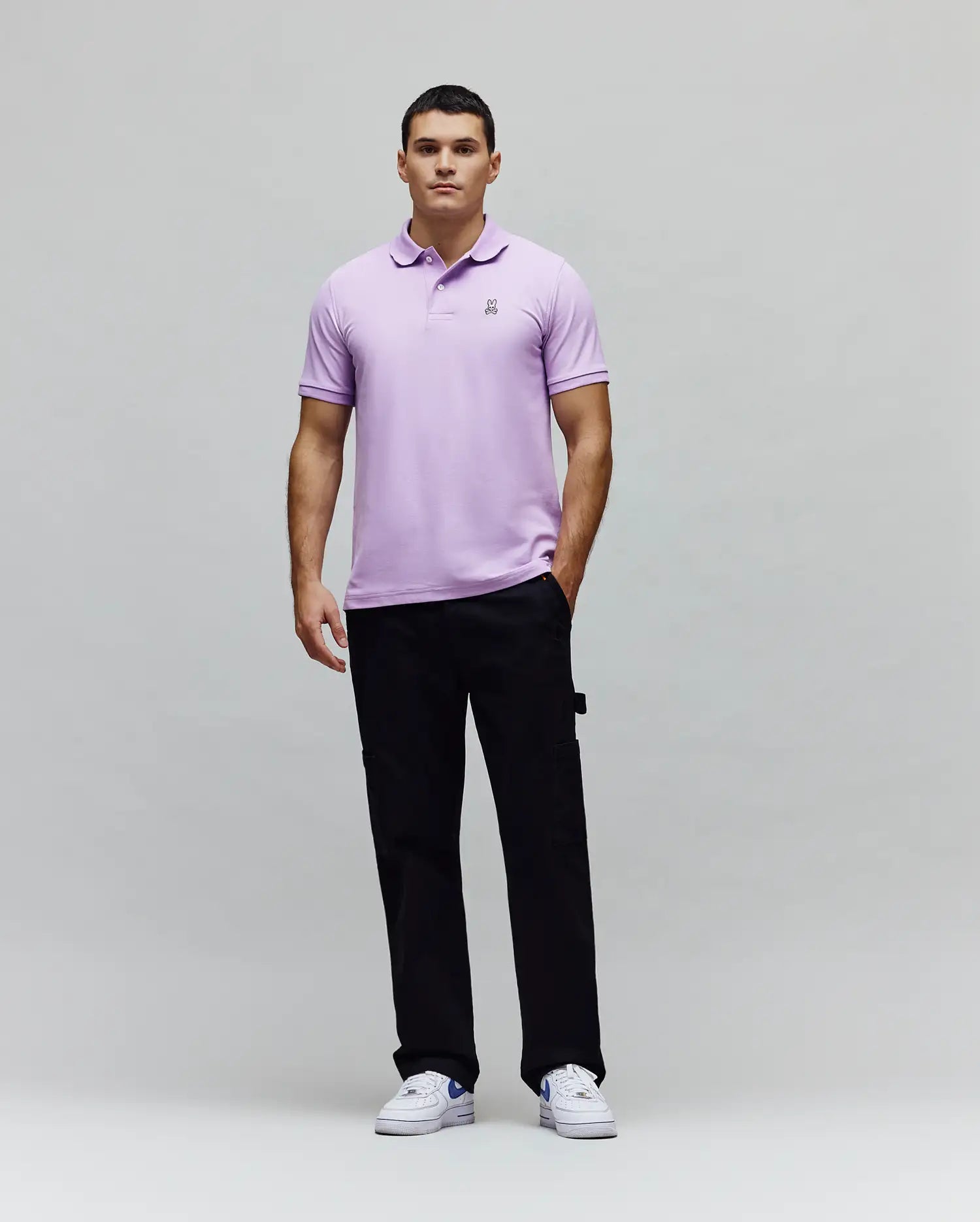 Mens Classic Pique Polo in lavender, crafted from textured pique fabric with a classic fit, featuring a small embroidered black and white Psycho Bunny skull logo on the left chest.