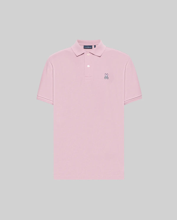 The Psycho Bunny MENS CLASSIC PIQUE POLO SHIRT (B6K001F200) is a light pink men’s polo in soft Pima cotton with short sleeves, a two-button collar, and an embroidered Bunny logo on the chest, shown on a plain gray background.
