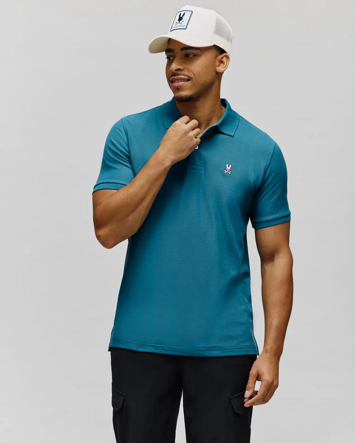 Mens Classic Pique Polo in rich teal, featuring a classic fit, textured pique knit, two-button placket, and a small embroidered white Psycho Bunny skull logo on the left chest.