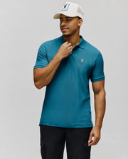 Mens Classic Pique Polo in rich teal, featuring a classic fit, textured pique knit, two-button placket, and a small embroidered white Psycho Bunny skull logo on the left chest.