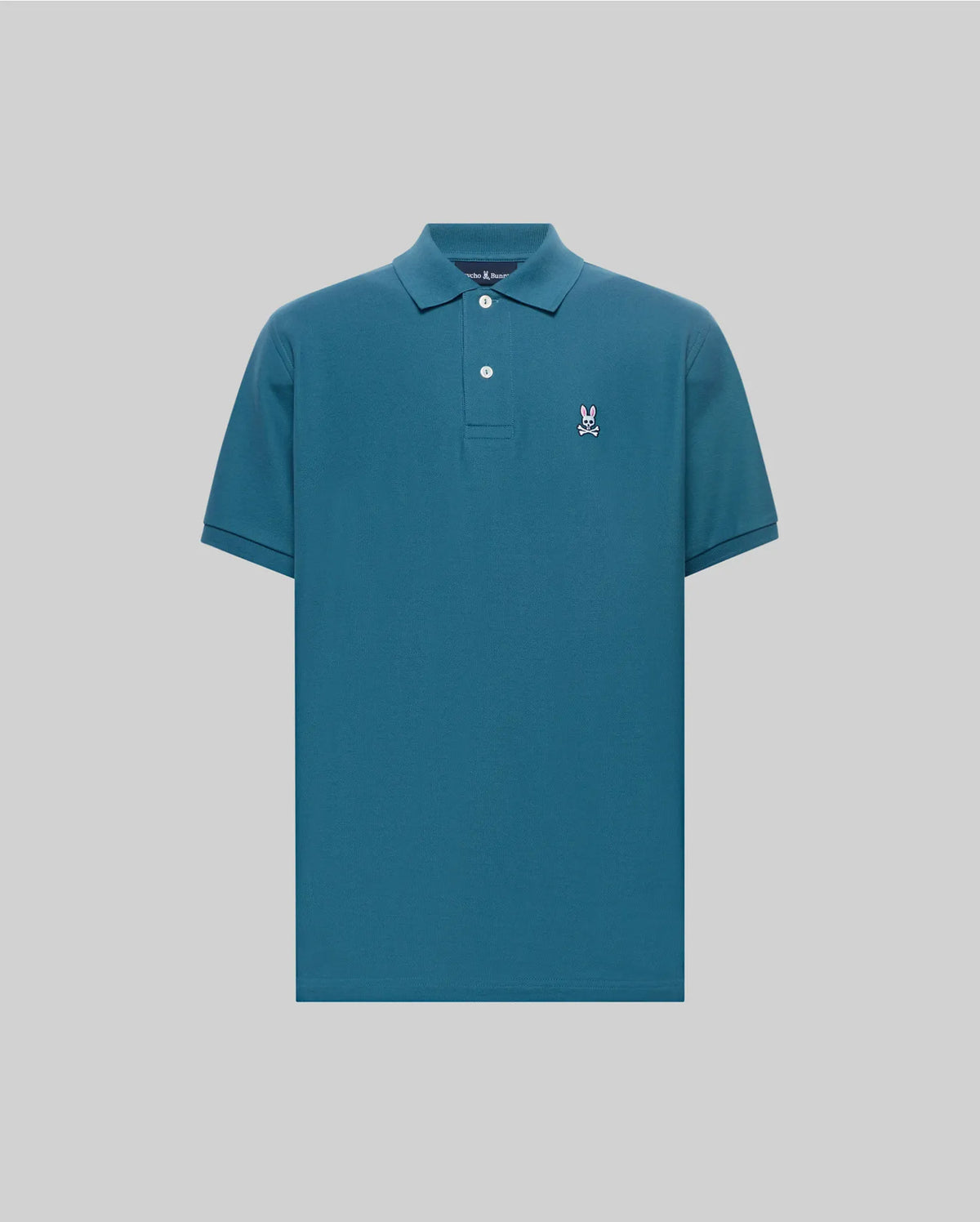 Mens Classic Pique Polo in deep teal, featuring a classic fit, pique knit texture, two white buttons, and a small embroidered white and pink Psycho Bunny skull logo on the left chest.