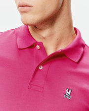 Mens Classic Pique Polo in vibrant fuchsia, featuring a classic fit, pique knit texture, two-button placket, and a small embroidered Psycho Bunny skull logo on the left chest. (3)