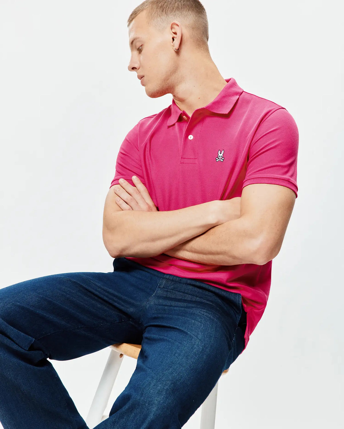 Mens Classic Pique Polo in hot pink, featuring a classic fit, pique knit texture, two white buttons on the placket, and a small white and black embroidered Psycho Bunny skull logo on the left chest. (4)