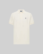 The Psycho Bunny MENS CLASSIC PIQUE POLO SHIRT (B6K001F200) is a cream-colored Pima cotton polo with a collar, button placket, and embroidered Bunny logo on the left chest, shown against a plain gray background.