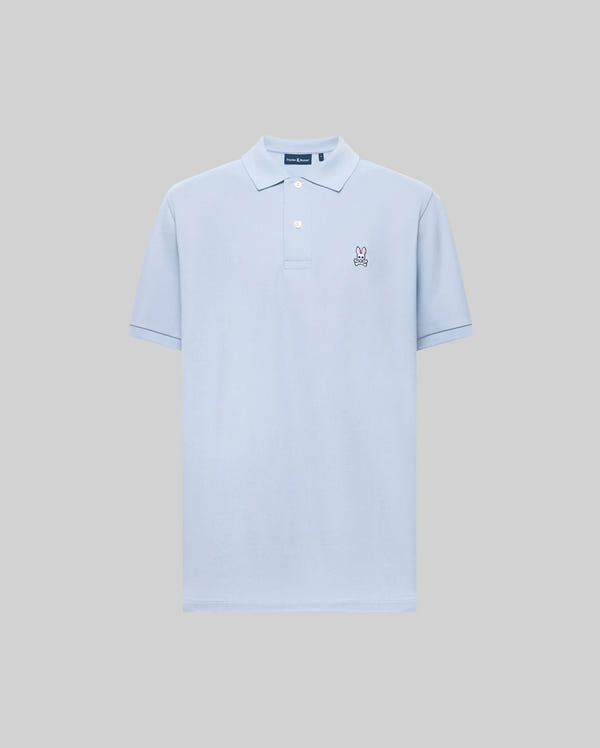 The Psycho Bunny MENS CLASSIC PIQUE POLO SHIRT (B6K001F200) is a light blue men’s polo made from soft Pima cotton, featuring short sleeves, a classic collar, two buttons, and an embroidered Bunny logo on the left chest.