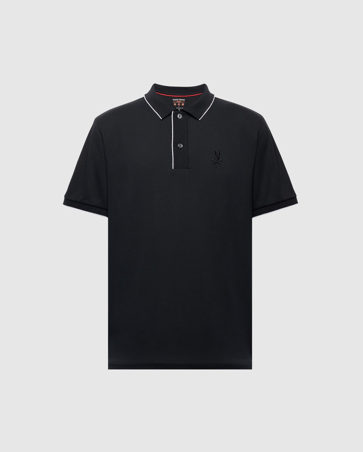 The Psycho Bunny MENS BRYCE PERFORMANCE PIQUE POLO (B6K486F200) is a black polo shirt with short sleeves, crafted from performance pique fabric, featuring white piping along the collar, a two-button placket, and a subtle embroidered logo on the left chest. Displayed against a gray background.