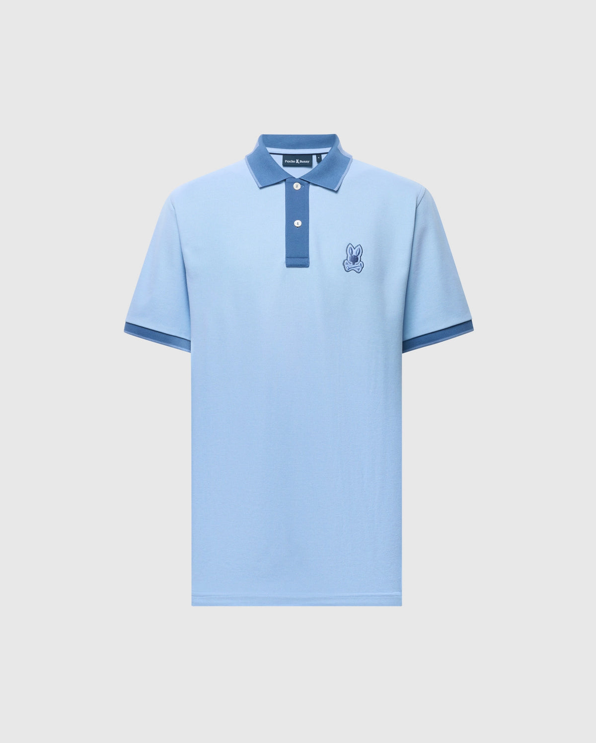 The Psycho Bunny Men's New Castle Pique Polo (B6K487F200) is a light blue slim fit with a navy collar and sleeve edges. It includes an embroidered bunny patch on the left chest, crafted from soft Pima cotton, featuring a two-button placket on a plain white background.