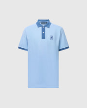 The Psycho Bunny Men's New Castle Pique Polo (B6K487F200) is a light blue slim fit with a navy collar and sleeve edges. It includes an embroidered bunny patch on the left chest, crafted from soft Pima cotton, featuring a two-button placket on a plain white background.