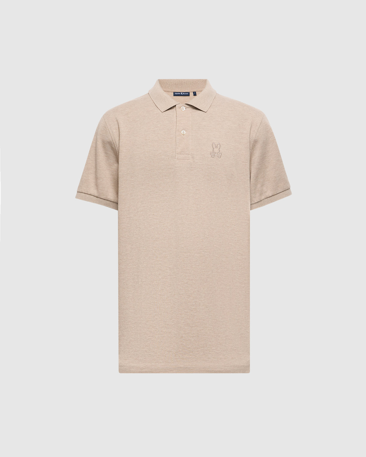 The Psycho Bunny Men's James Premium Pique Polo Shirt - B6K945D200 is a beige, lightweight polo crafted from durable Pima cotton. It includes a collar, short sleeves, and features an embroidered design on the left chest.